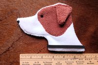 Smudge Dog shown with a ruler to demonstrate size.
