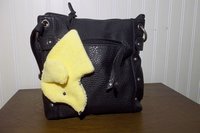 Smudge Dog attached to black purse.