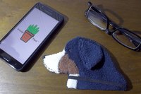 Smudge Dog with phone and glasses. Two of the items it can clean