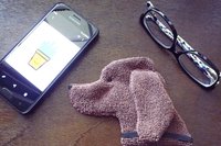 Smudge Dog with smart phone and glasses.