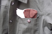 Smudge Dog peeking out of jean jacket pocket