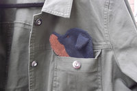 Smudge Dog peeking out of jean jacket pocket