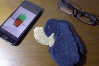 Smudge Dog with smart phone and glasses.