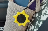 Sunflower on beach bag on car seat.