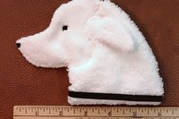 Smudge Dog shown with a ruler to illustrate size