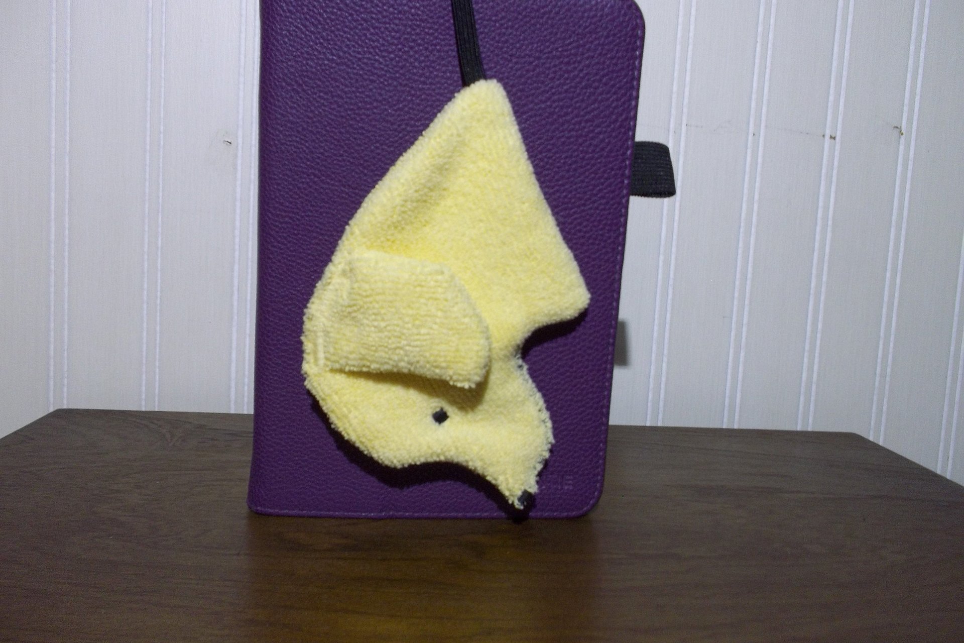 Smudge Dog attached to the case of an e reader.