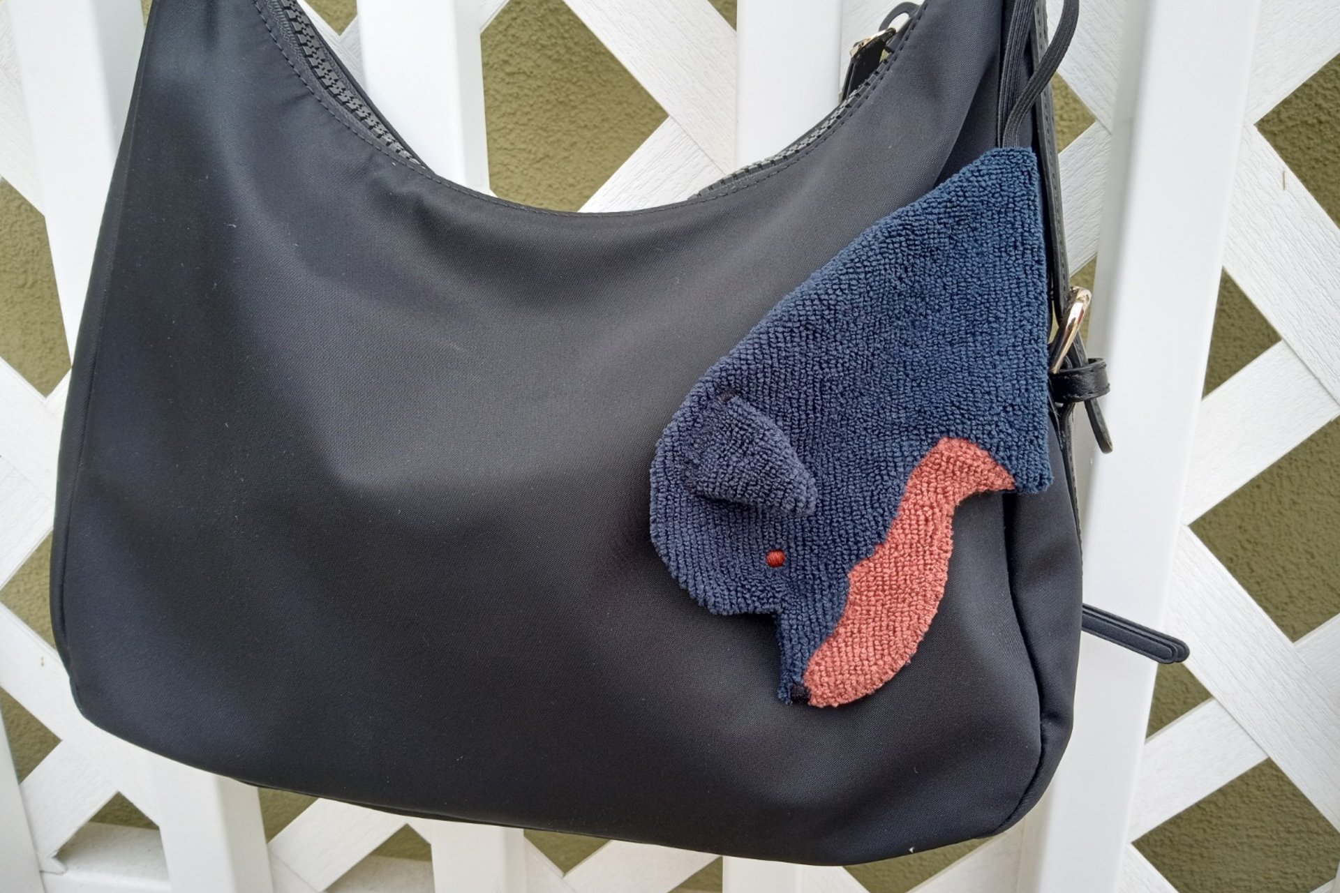 Smudge dog attached to a handbag always within reach.