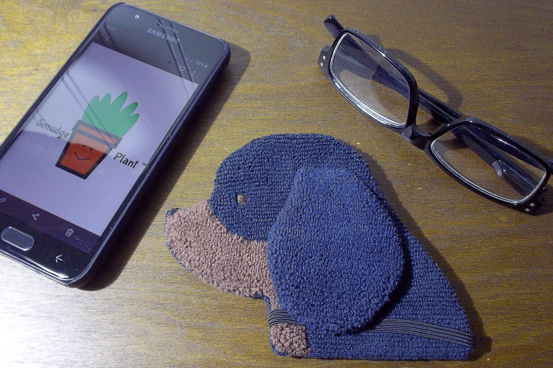 Smudge Dog with smart phone and glasses.